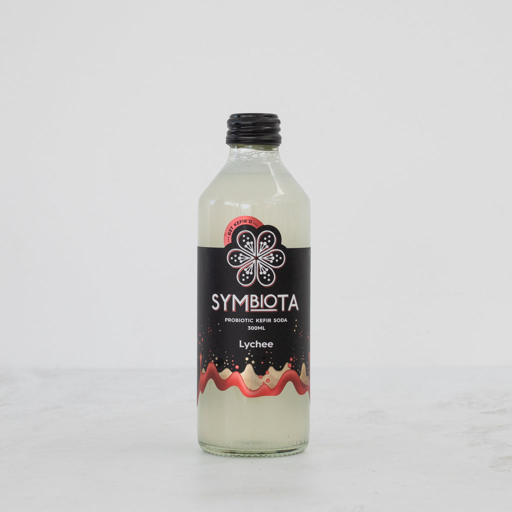 bottle of lychee probiotic kefir soda by symbiota